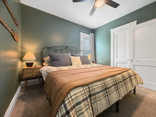 a bedroom with a bed and a ceiling fan at Chic Lakeside Retreat Steps from the Beach in Cleveland