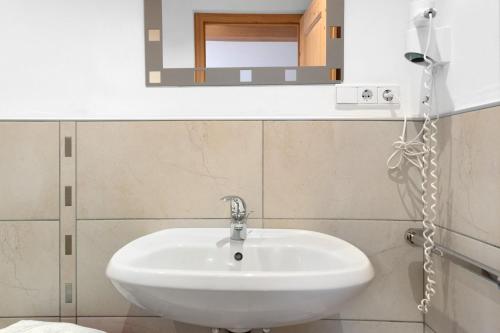a bathroom with a white sink and a mirror at Rielingerhof in Collalbo
