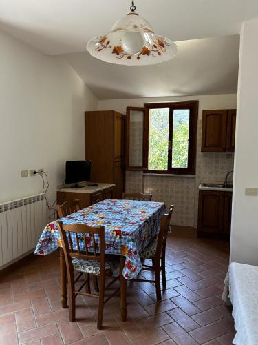a kitchen with a table with chairs and a dining room at Da Davide in Marciana Marina