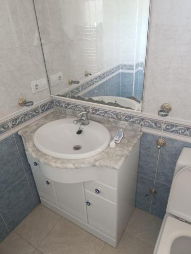 a bathroom with a sink and a mirror at Westmorland in Busot
