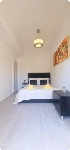 a bedroom with a large white bed in a room at Joana's room 2 in Lisbon