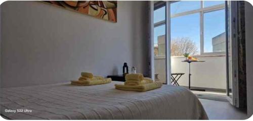 a bedroom with a bed with two towels on it at Joana's room 2 in Lisbon