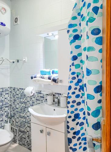 a bathroom with a sink and a mirror at Résidence Riviera beach in Cabo Negro