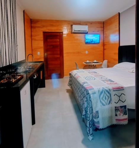 a hotel room with a bed and a sink at UrbanStay Flats in João Pessoa