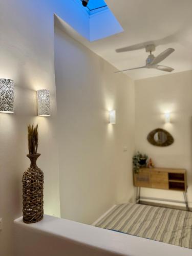 a vase sitting on a shelf in a room with a ceiling at Cycladic Sand The House in Ios Chora