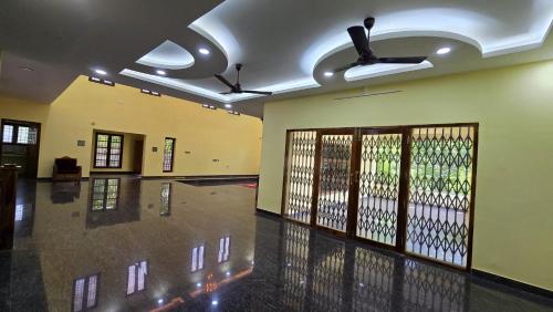 an empty room with a gym with doors and ceilings at Luxe Haven Stay in Puducherry Airpoert