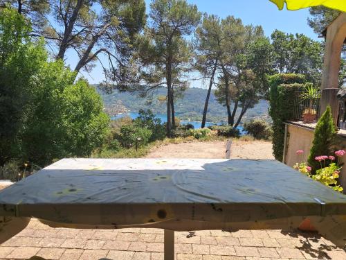 a table with a blue cover on a patio at Panoramic lake view in Esparron-de-Verdon