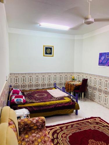 a bedroom with a bed and a table in a room at Heritage House in Nizwa