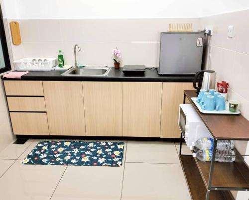 a kitchen with a sink and a counter top at JB Austin Regency Simple N Tidy 5pax PLUS 1 in Johor Bahru