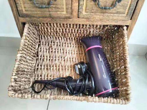 a hair dryer in a basket on the floor at JB Austin Regency Simple N Tidy 5pax PLUS 1 in Johor Bahru