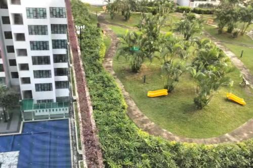 an aerial view of a resort with a pool and palm trees at JB Austin Regency Simple N Tidy 5pax PLUS 1 in Johor Bahru
