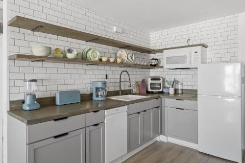 a white kitchen with a sink and a refrigerator at Town of Lewes --- 8 Georgia Ave. Unit 2 in Lewes