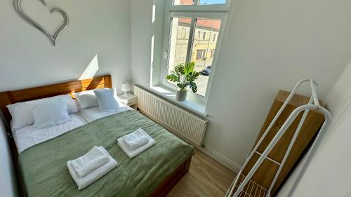 una piccola camera da letto con un letto e una finestra di Przytulny i słoneczny apartament nr 1 Góry Sowie, Jezioro, Centrum a Bielawa