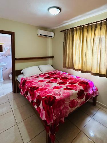 a bedroom with a bed covered in red roses at Aparthotel Michaela in Sosúa