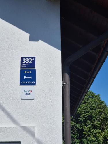 a blue sign on the side of a building at Kika apartmani-FREE PARKING- 7 km od centra in Zagreb