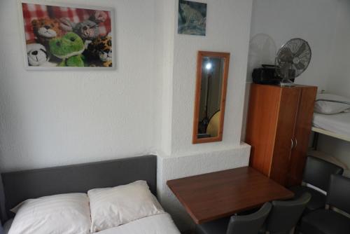 a room with a bed and a table and a mirror at Hotel Schroder in Amsterdam