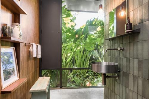 a bathroom with a sink and a large window at Muli Muli in Ocean Shores