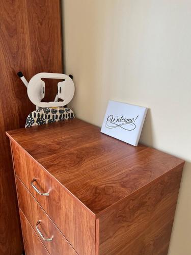 a wooden dresser with a box on top of it at Chic City Apartment in Castries
