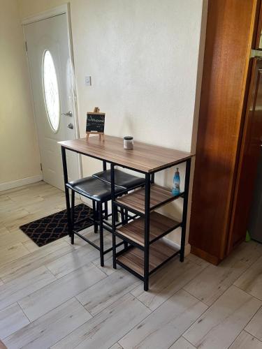a wooden table with two chairs and a table at Chic City Apartment in Castries