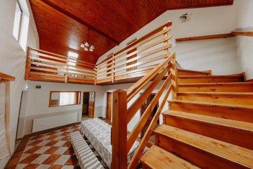 a room with wooden stairs in a house at Pensiunea Patakparti 2 in Praid