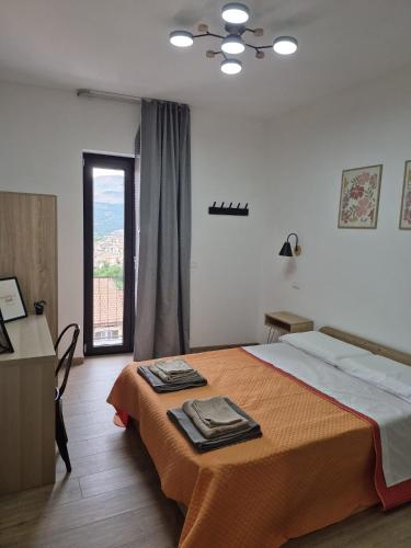 a bedroom with a bed and a large window at B&B La Casetta di Cecè in Celano