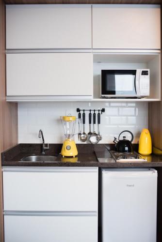 Una cocina o zona de cocina en Studio Prático Próximo ao Aeroporto