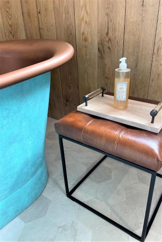 a bottle of soap sitting on top of a stool at 1 & 2 bedroom Weaver's Cottages at Frame Farm in Benenden