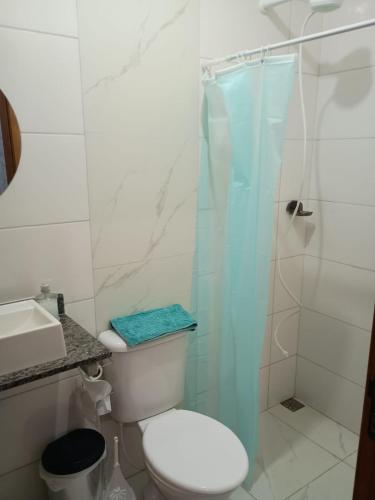 a bathroom with a toilet and a glass shower at Parque Ecológico Studios in Indaiatuba
