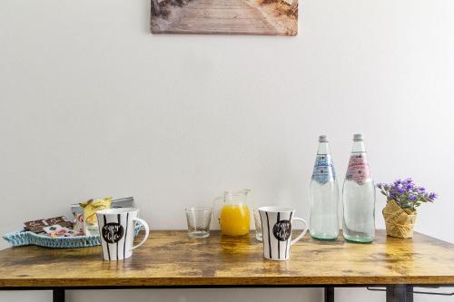 a wooden table with bottles on top of it at Blanche Apartments in Porto Torres