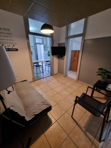 a living room with a couch and a table and chairs at Rota Ria Alojamento Local in Aveiro