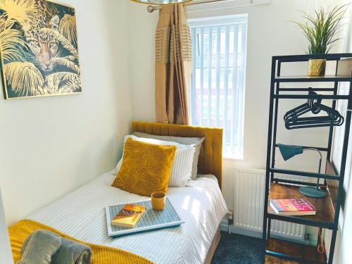 a bedroom with a bed with a tray on it at Ideal 4 Bed Home sleeps 7 Nr Middlebrook Stadium in Lostock