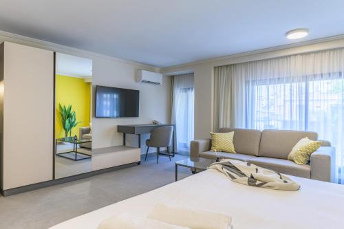 a living room with a couch and a table at CityZen - Boutique Studios in Achrafieh in Beirut