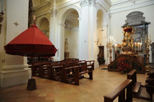 a large church with benches and a red altar at Trevi al Centro in Trevi