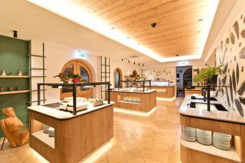 a large room with a kitchen with sinks and counters at Flackl - Wirt in Reichenau