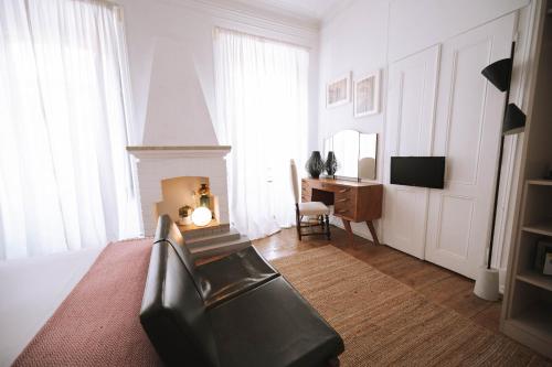 a bedroom with a bed and a desk and a chair at House Sao Bento in Lisbon