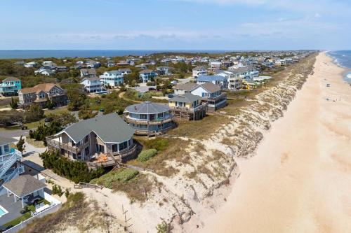 an aerial view of a row of houses on the beach at Pelican Post in Sanderling