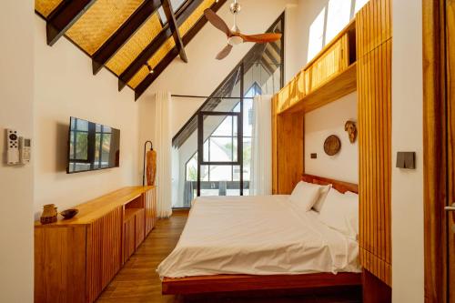 a bedroom with a bed and a large window at Emerald Villas by Paje Emerald Escapes Ltd in Paje