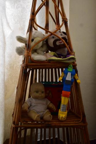 a wooden cage filled with stuffed animals and a doll at Hiti fusa in Pātan