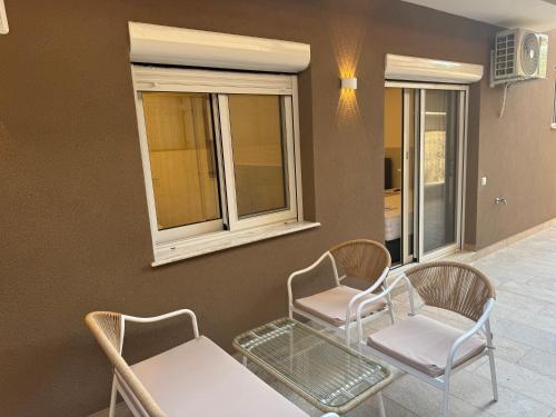 a waiting room with two chairs and a table at The Elegant Areti in Olympiaki Akti