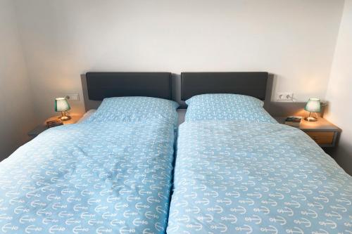 Ένα ή περισσότερα κρεβάτια σε δωμάτιο στο KÜSTE33/44 - Neues Apartment mit Sauna in Strannähe