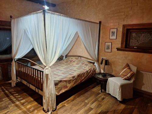 a bedroom with a canopy bed and a table at Rent in summer in Ragaciems