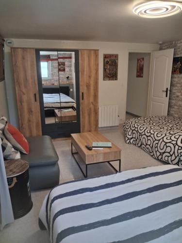 a hotel room with two beds and a table at Appartement au calme proche d'un petit bois dans quimper in Quimper