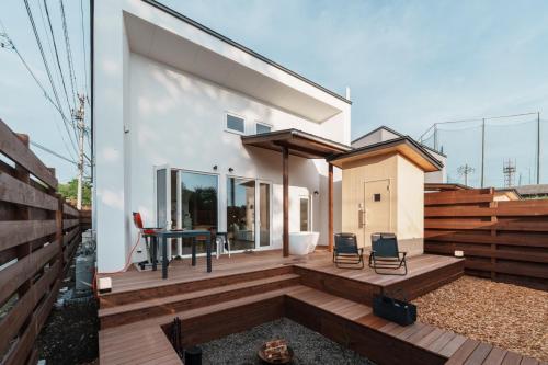 a house with a deck with a table and chairs at - YURAGI - TSUKI me CHILL in Oiwake