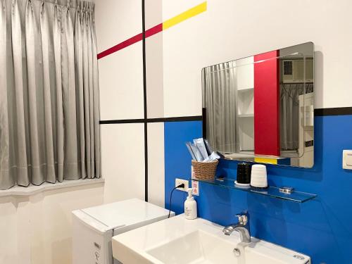 a bathroom with a sink and a mirror at Chihkan Mansion in Tainan