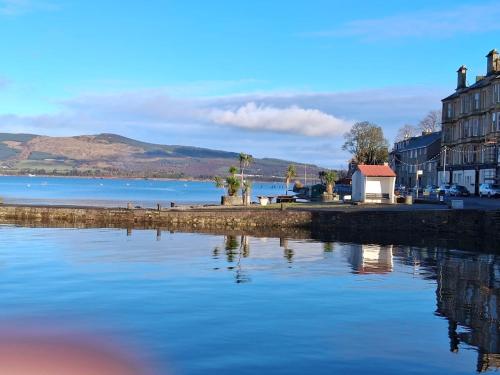 a view of a body of water with houses and buildings at The Port in Port Bannatyne