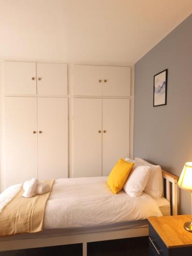a bedroom with a bed with white cabinets at Cosy 3 bed house in Doncaster in Kirk Sandall