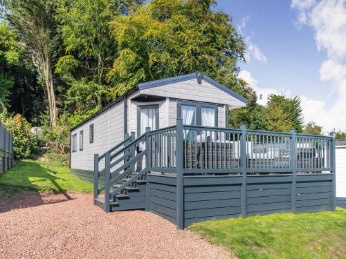 a small cabin with a gate and a fence at Red Wood Lodge - Uk40849 in Scarborough