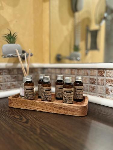 four jars of honey on a wooden tray on a counter at SoloApartment in Sunny Beach