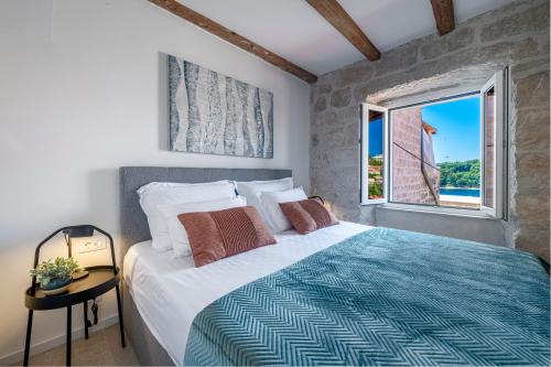a bedroom with a large bed and a window at Villa Mareta Cavtat in Cavtat