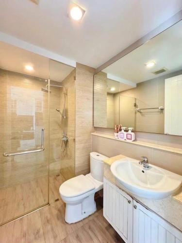 a bathroom with a toilet and a sink and a shower at Blu X Bangsaen97 in Bangsaen